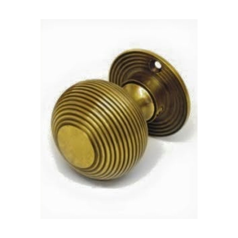 Decorative reeded knob on rose, aged brass